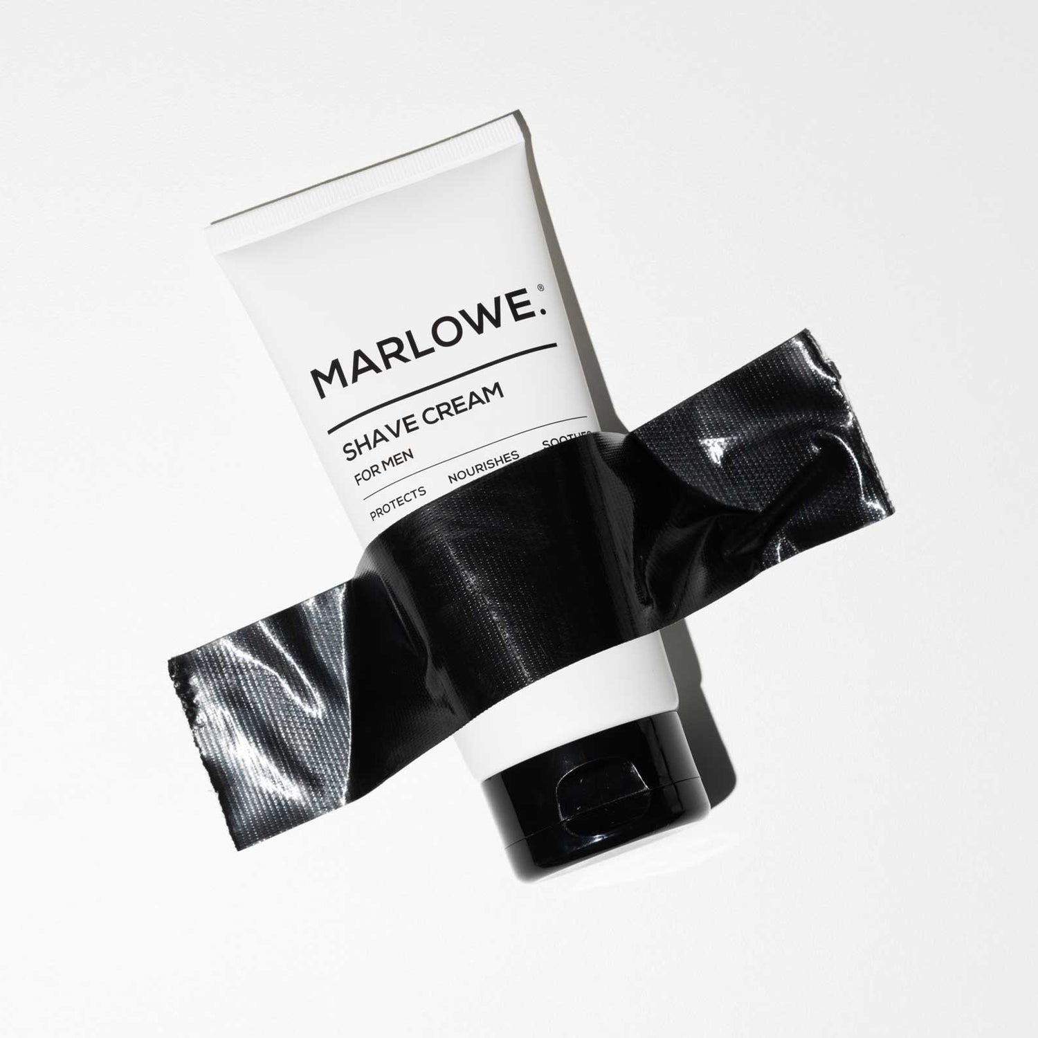 MARLOWE. Shave Cream taped to wall with black tape