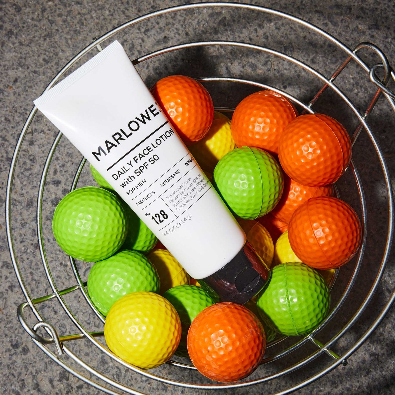 MARLOWE. Face Lotion with SPF in bucket with golf balls